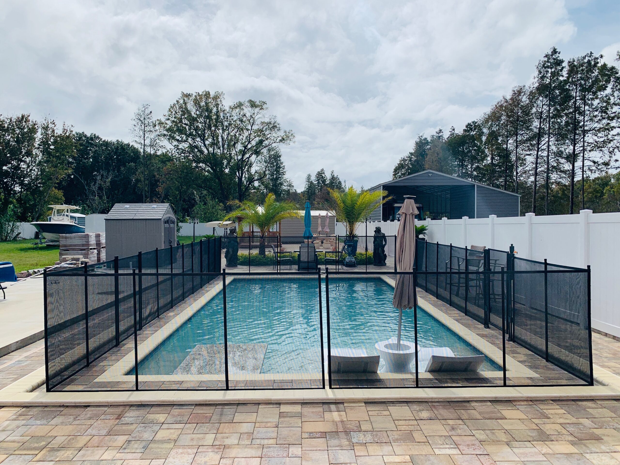pool safety fence around pool in backyard